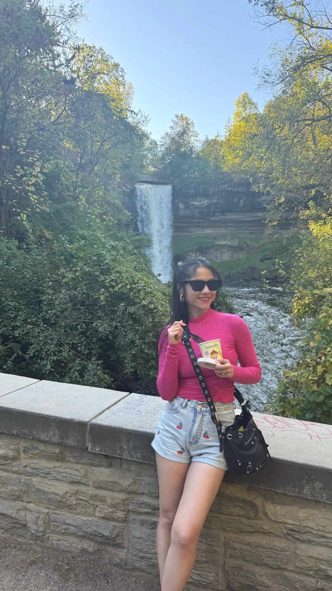 Enjoying a KneadFit cake on a hike by the falls